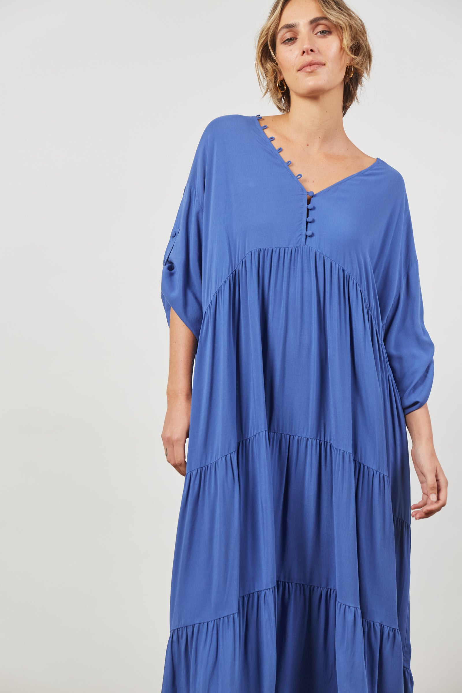 ladies azure blue maxi dress v neck with button loop detail gathering under bust. long sleeves with tab
