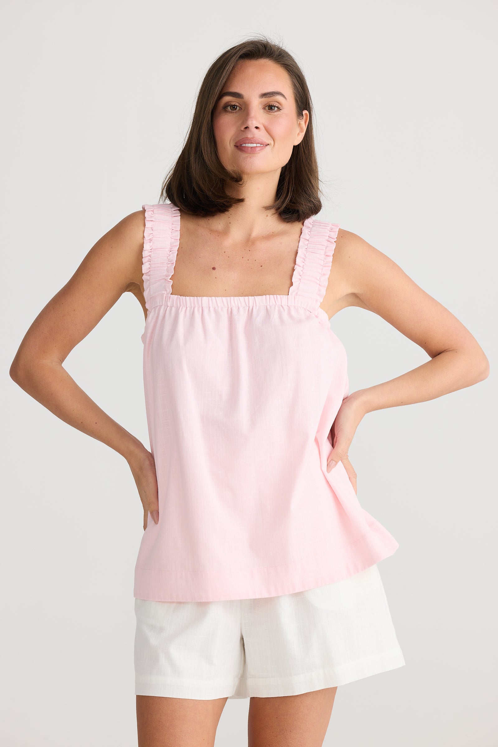 Model wearing the pink penny tank top by Holiday Clothing.