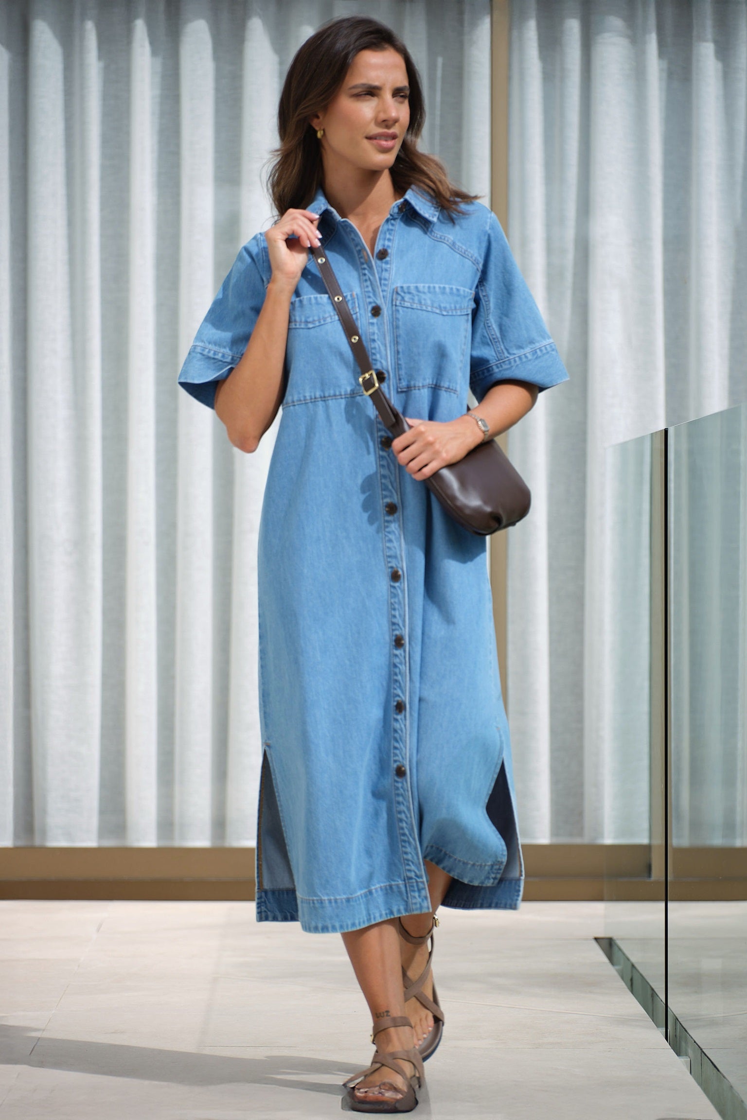 Model wearing Ava Short Sleeve Yoke Detail Midi Denim Dress in Vintage Blue with Button Front and pockets by Ceres Life.