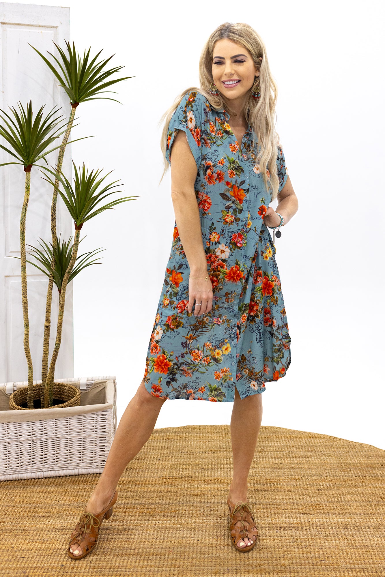 Woman wearing Cienna's Bridget Buttoned Dress a shirt dress style floral print midi dress.