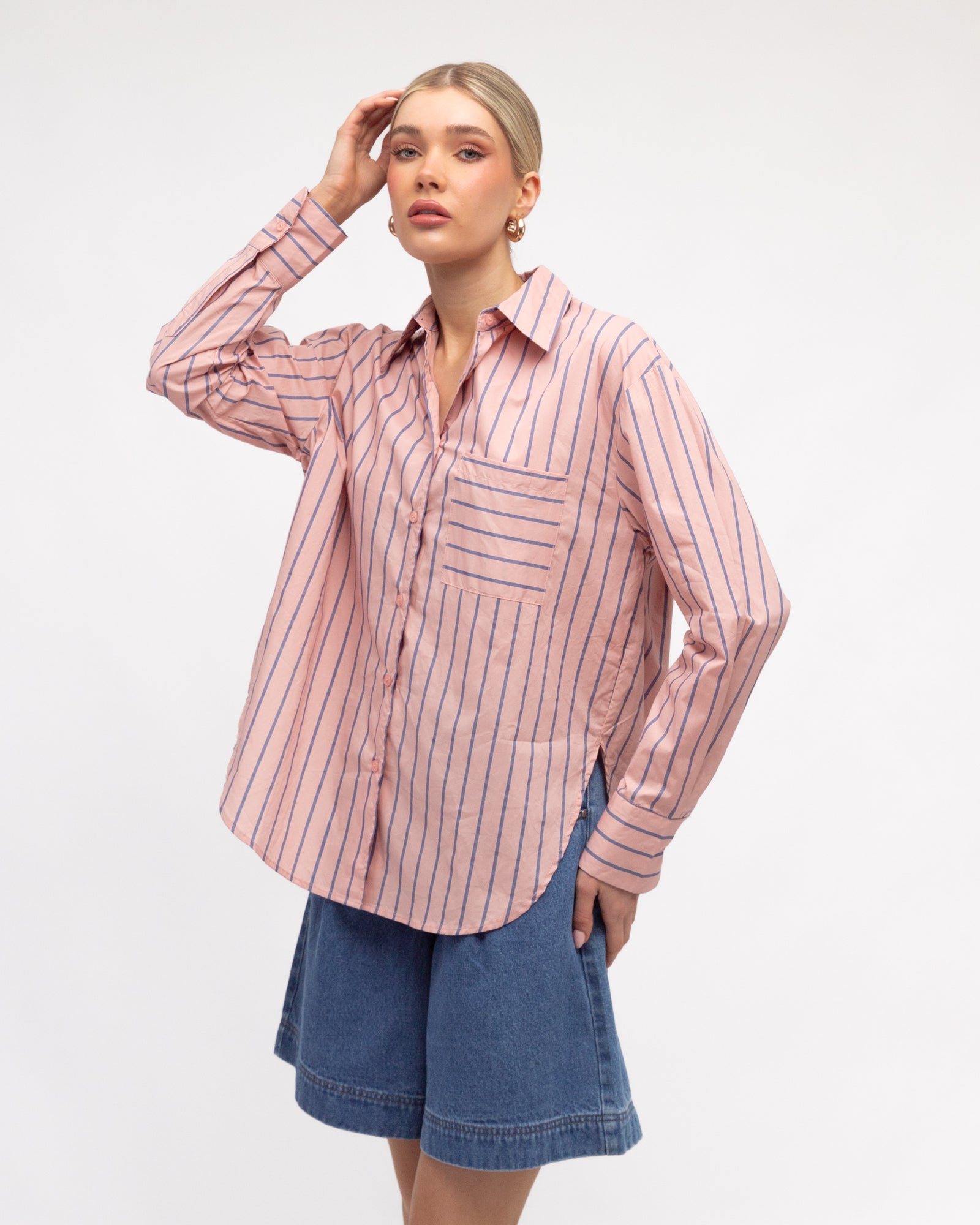 Woman wearing the Caddy Striped long sleeve Shirt in dusty pink and blue by White Closet.
