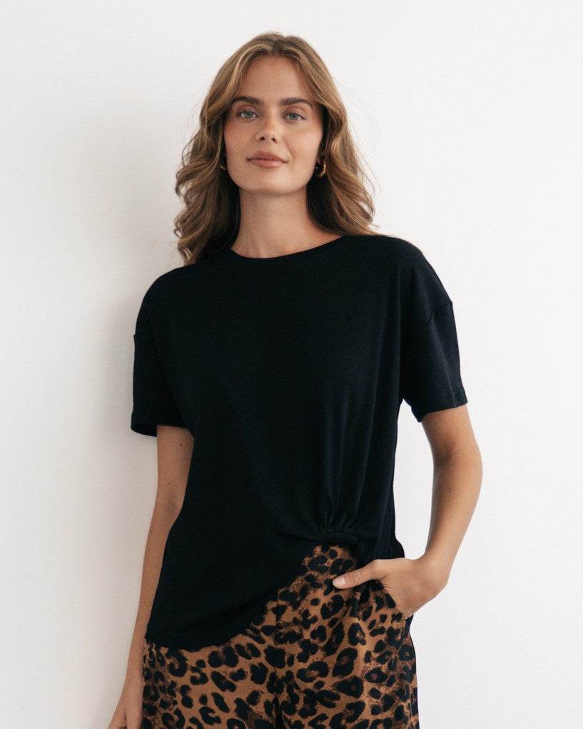 Woman wearing the black Tuck t-shirt with short sleeves, round neck, straight hem by Label of Love.