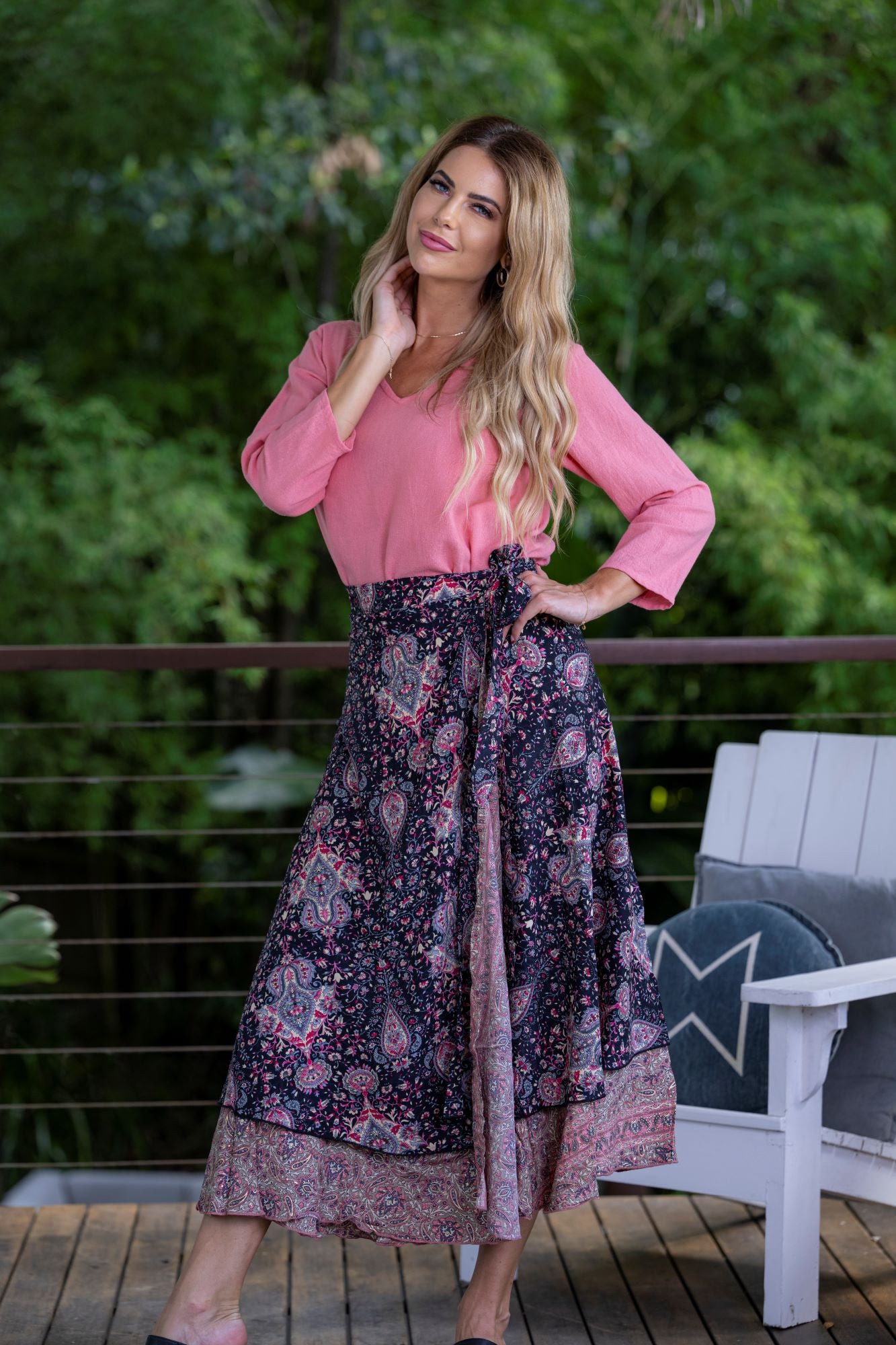 Woman wearing Boho Silk blend reversible navy blue and pink paisley floral maxi wrap skirt by Cienna.
