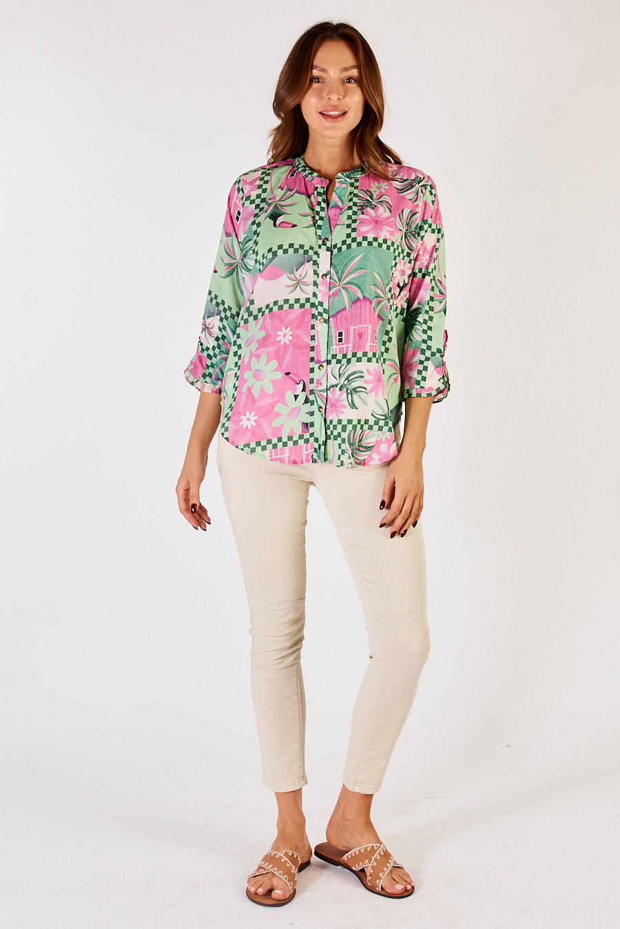 Front of pink and green tropical print women's shirt with 3/4 sleeves and button up front.