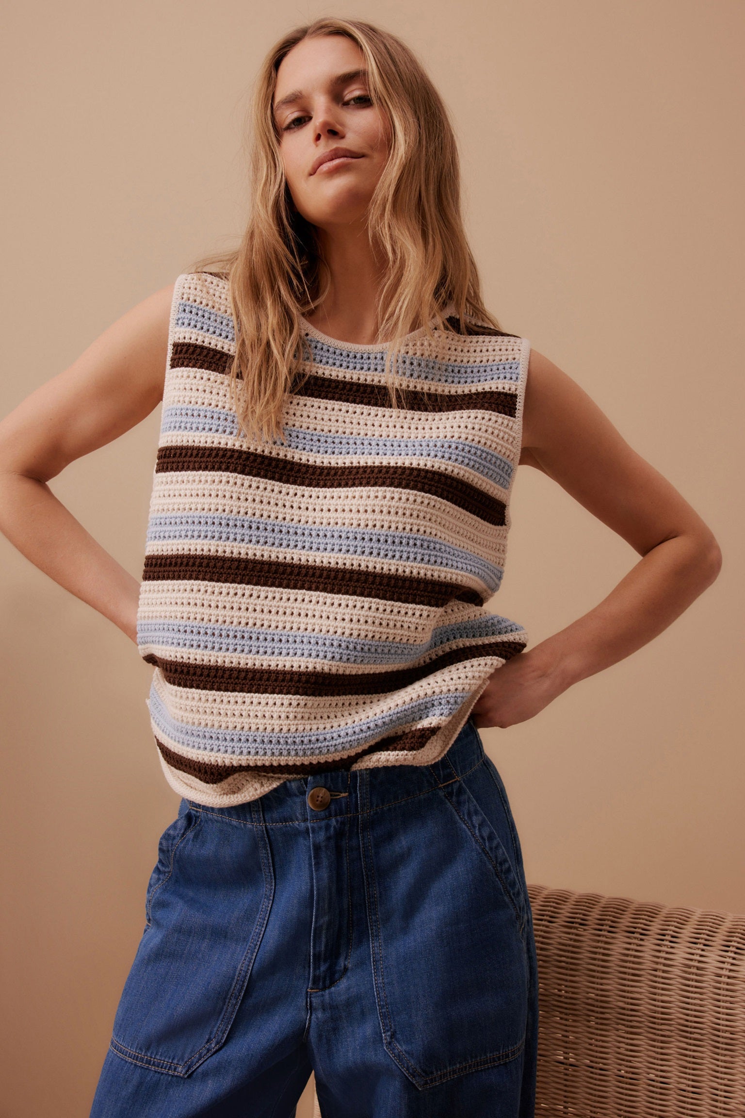 Model wearing striped white ecru, chalk, blue and chocolate brown sleeveless margot knit tank top by ceres life.