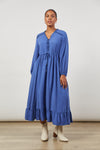 Ladies Blue Euphoria Maxi Dress, V Neck with Ruffle Detail across shoulders and on placket. Drawstring waist with tie detail. long sleeves with elastic cuff. wide ruffle / frill along hem