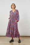 front view of women's maxi romance tiered dress  v-neck with detailing, gorgeous floral print all over, long sleeves