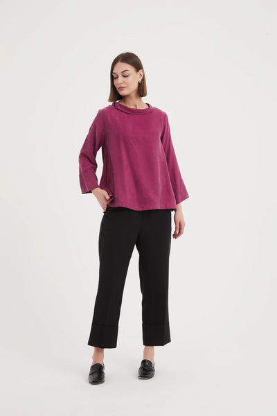 ladies women pink blouse with wide sleeves and a mock neck front of model