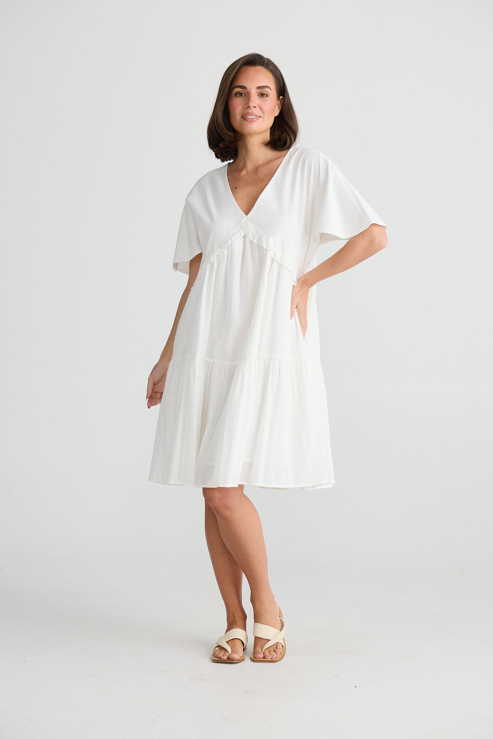 Model Wearing Lola Tiered Cotton Midi dress in White by Holiday. 