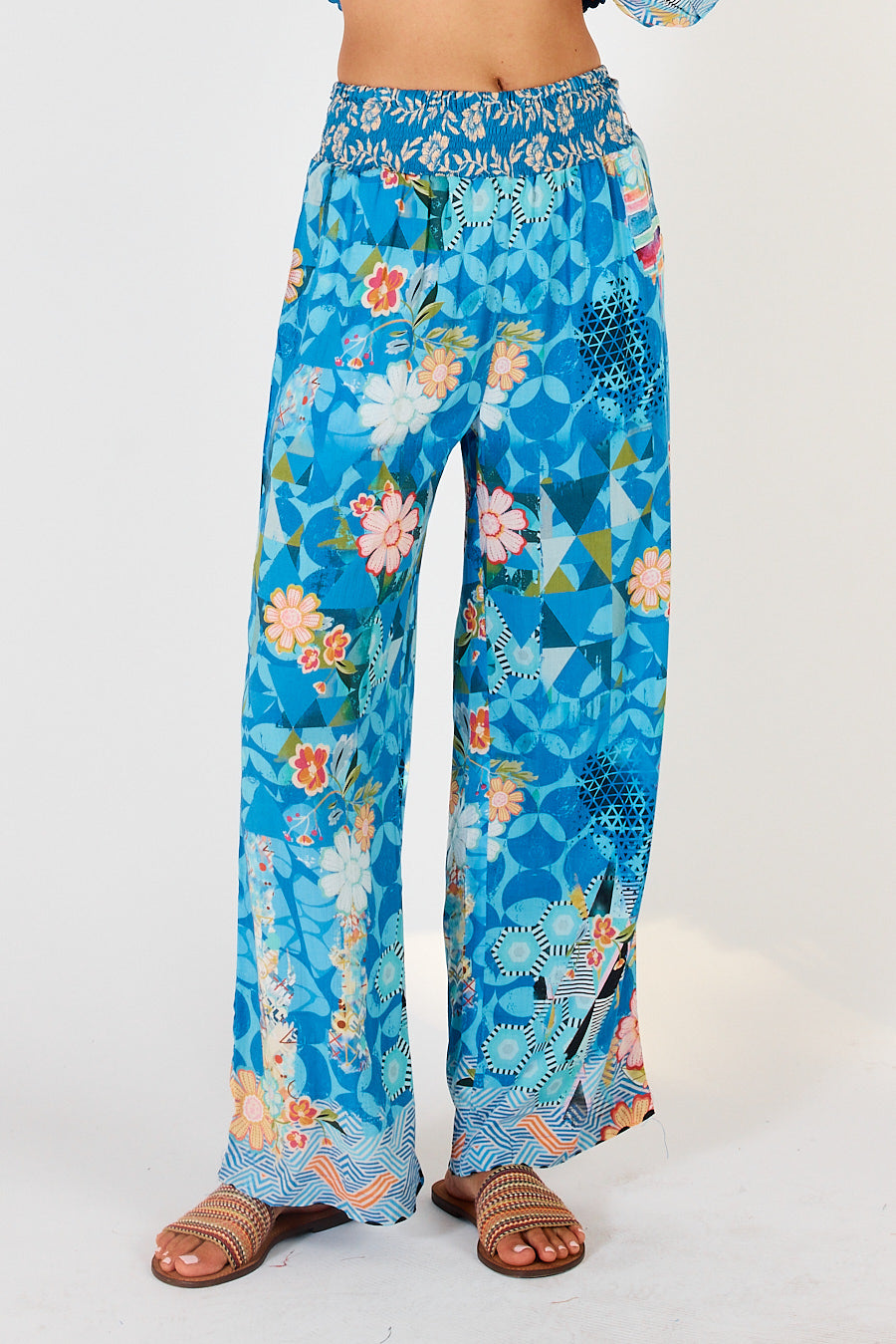 Amalfi summer trousers in blue, white, yellow flower and geometric print with elasticated waist and are full length.