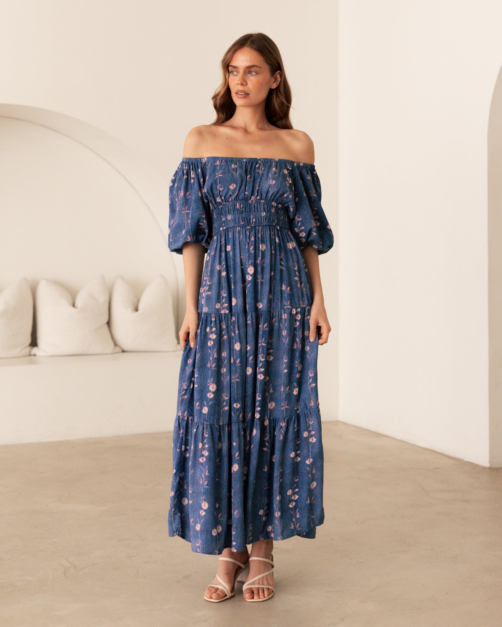 Woman wearing the Ebby & I Sweet Sensations maxi dress with puff sleeves, on or off shoulders, gathering under bust and tiered skirt.