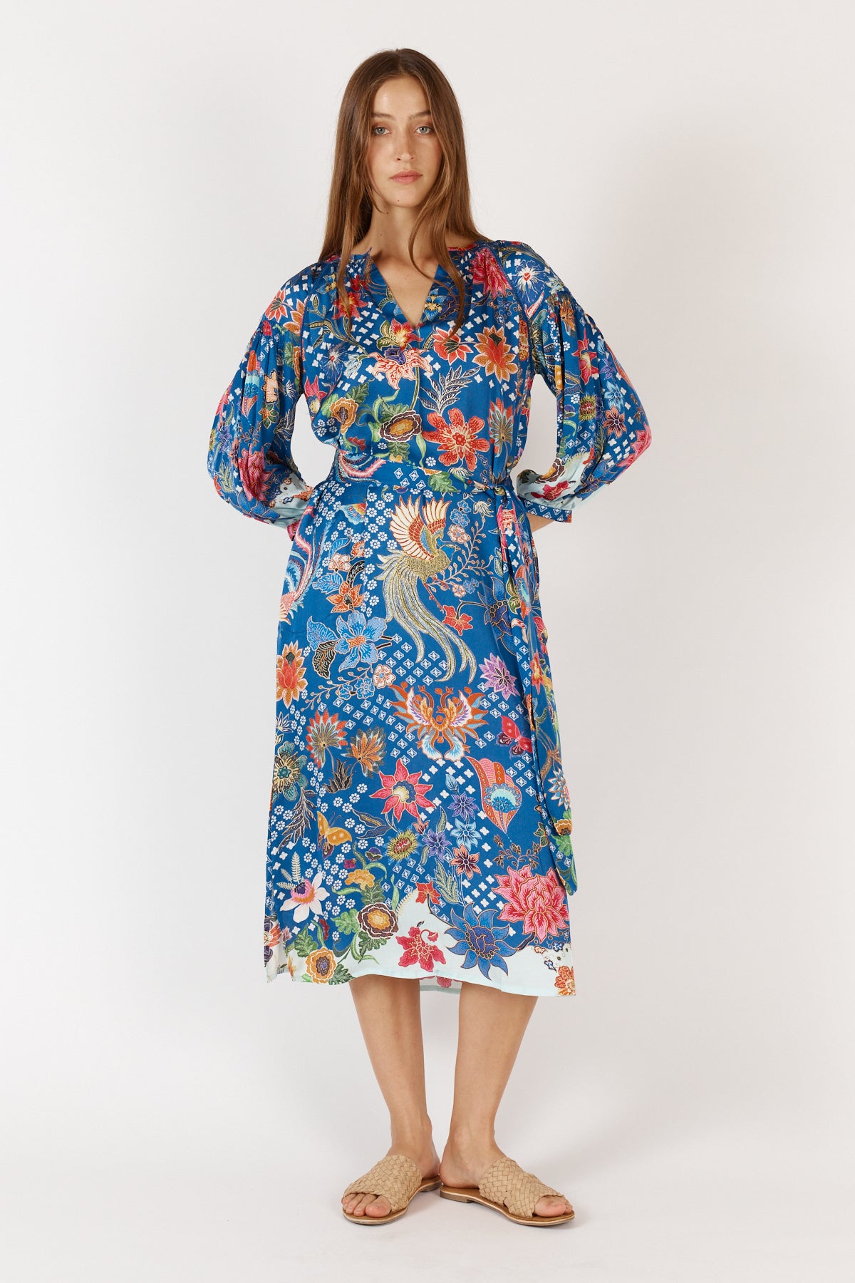 Woman weraing floral blue Toscana Satin Midi Dress with long sleeves, collar and tie waist.