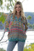 Model wearing Cienna's boho Carmen geometric multi shirt with long sleeves.