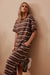 Woman wearing Ceres Life's Charlotte Maxi Dress in chocolate and white stripes with side splits, short sleeves and round neck in terry cotton.