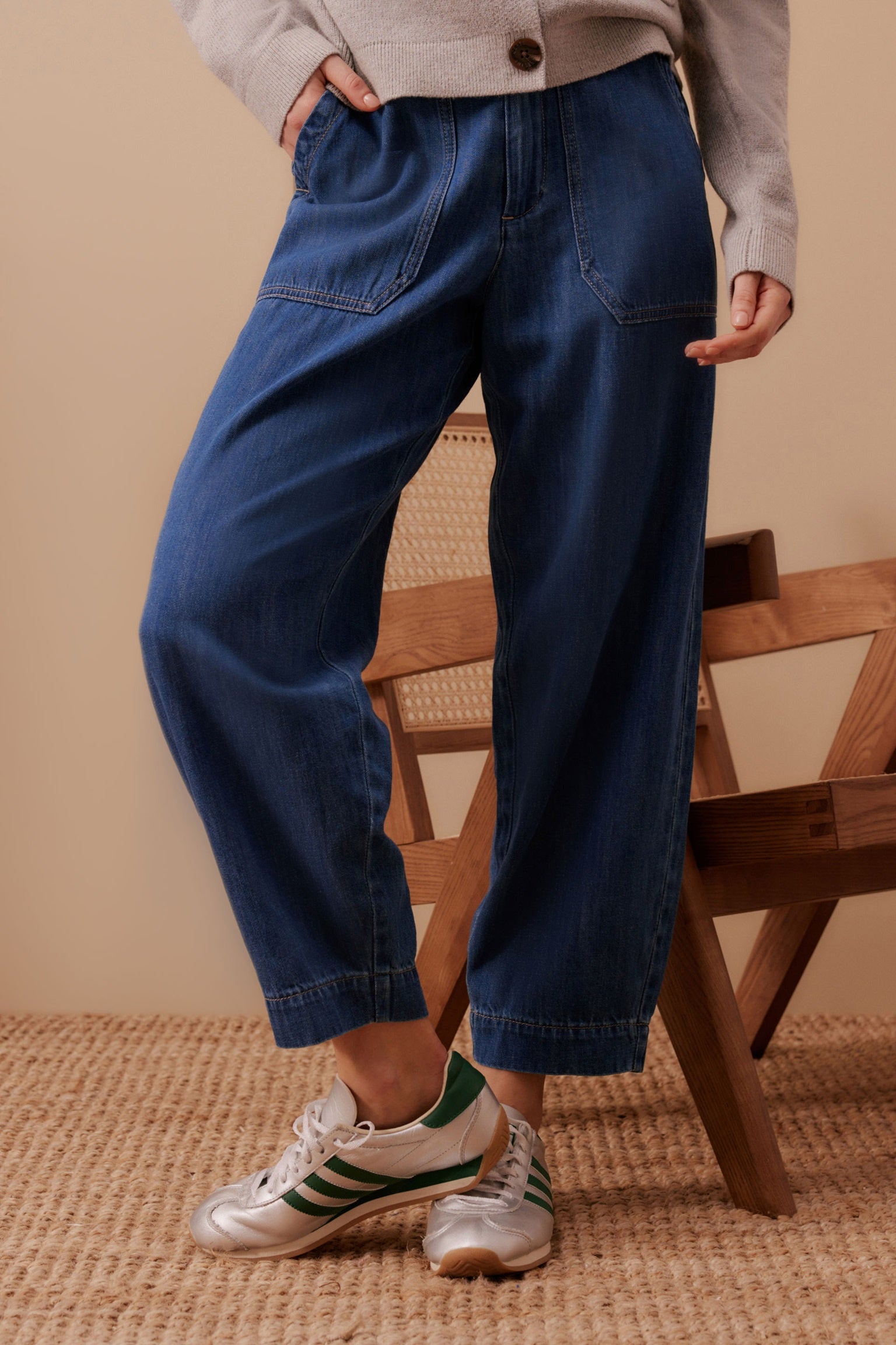 Woman wearing Ceres Life's Weekender Denim Jean Pants in Deep Indigo Blue with a full length and patch pockets.