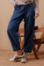 Woman wearing Ceres Life's Weekender Denim Jean Pants in Deep Indigo Blue with a full length and patch pockets.