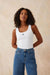 Woman wearing a sleeveless black scoop neck tank top with monogrammed ceres life on the front in white.