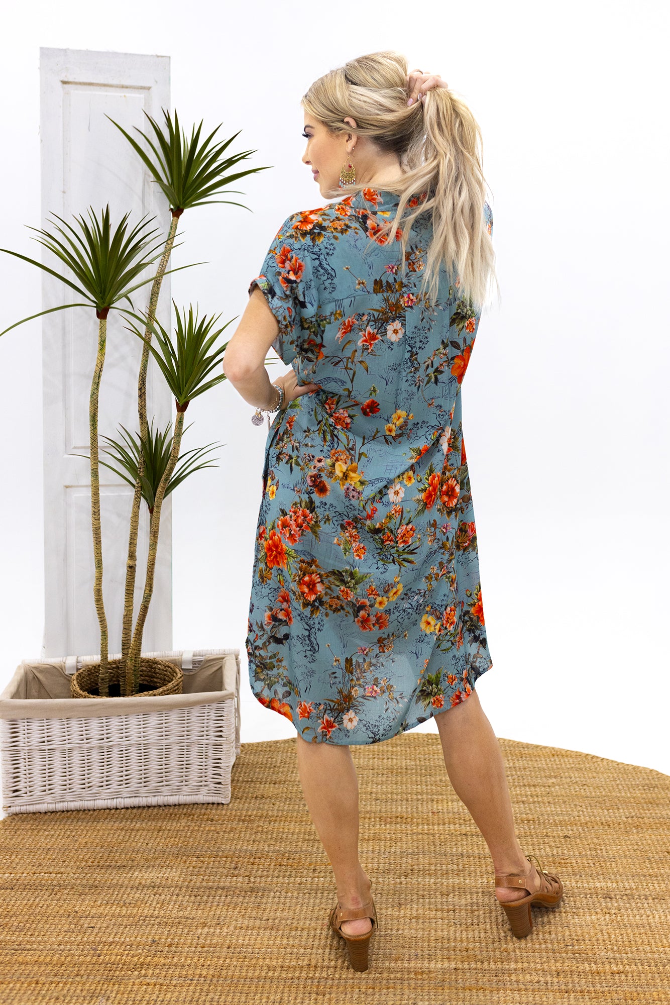 Woman wearing Cienna's Bridget Buttoned Dress a shirt dress style floral print midi dress.