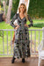 Lady wearing Cienna's Silk blend Myra Bohemian maxi dress with a v-neck, shirred under bust, long sleeves and a tiered skirt with ruffles in a goregous black, green, blue and honey toned floral paisley print.