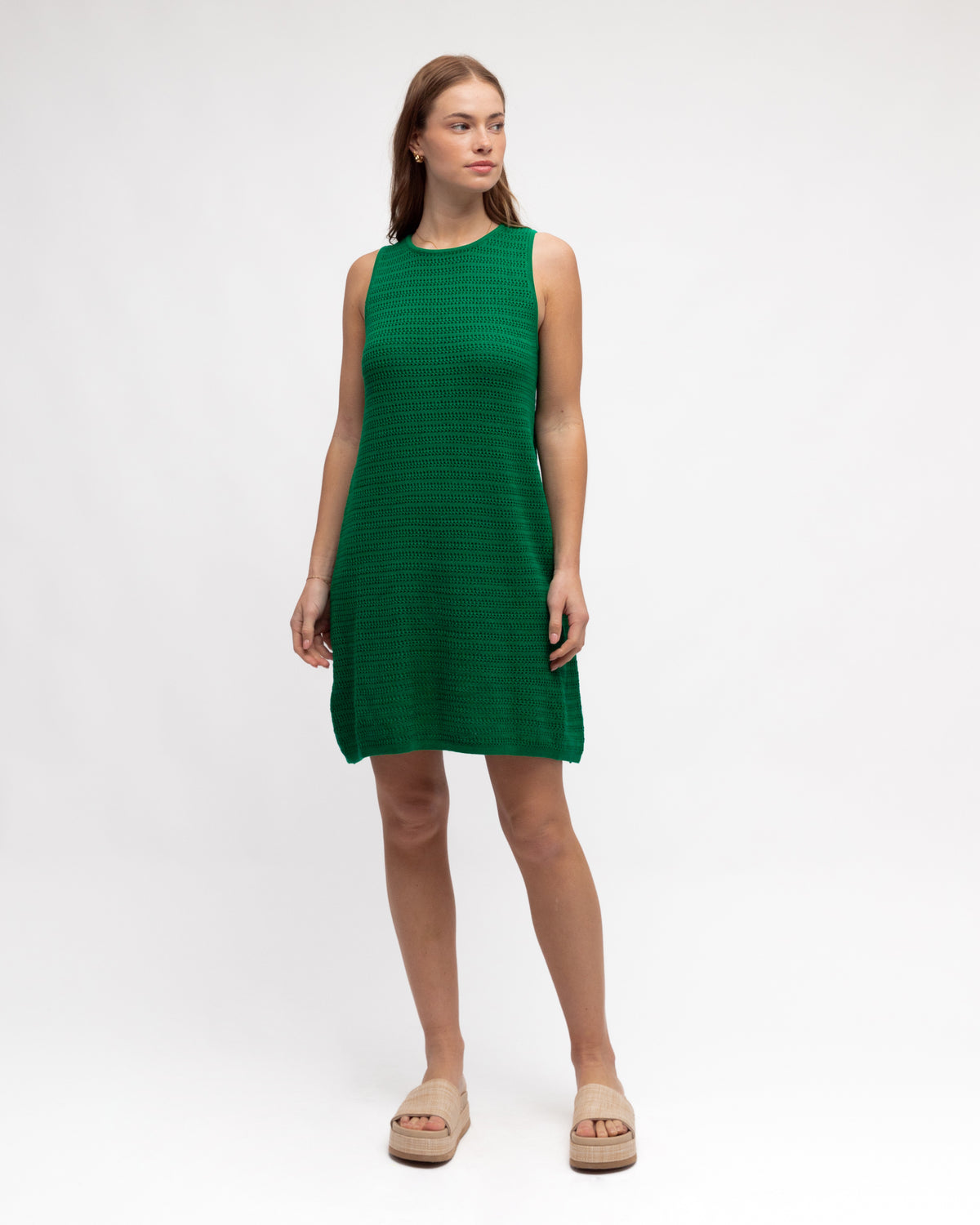 Woman wearing the crew neck, knit emerald green cotton dress by paper heart.