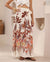Woman wearing tropical brown and white maxi wrap skirt by Iris Maxi.