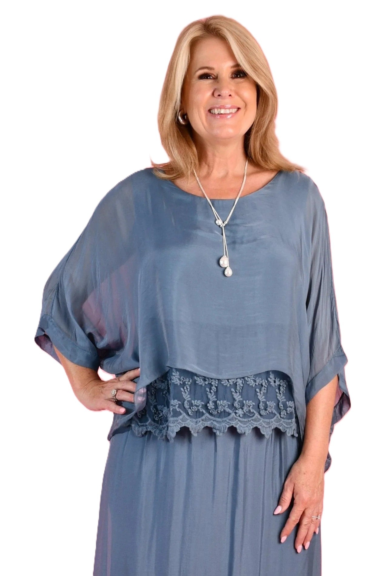 Woman wearing the Marta light blush pink silk blend top with lace inset, floaty sleeves and a round neckline by La Sofia.