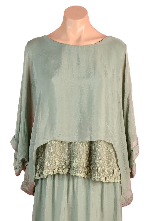 Mannequin wearing the Marta sage green silk blend top with lace inset, floaty sleeves and a round neckline by La Sofia.