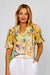 Woman wearing the tropical frill collar shirt by La Strada with short leeves, vneck in orange, blue, green and beige with flowers, birds of paradise and butterflies.