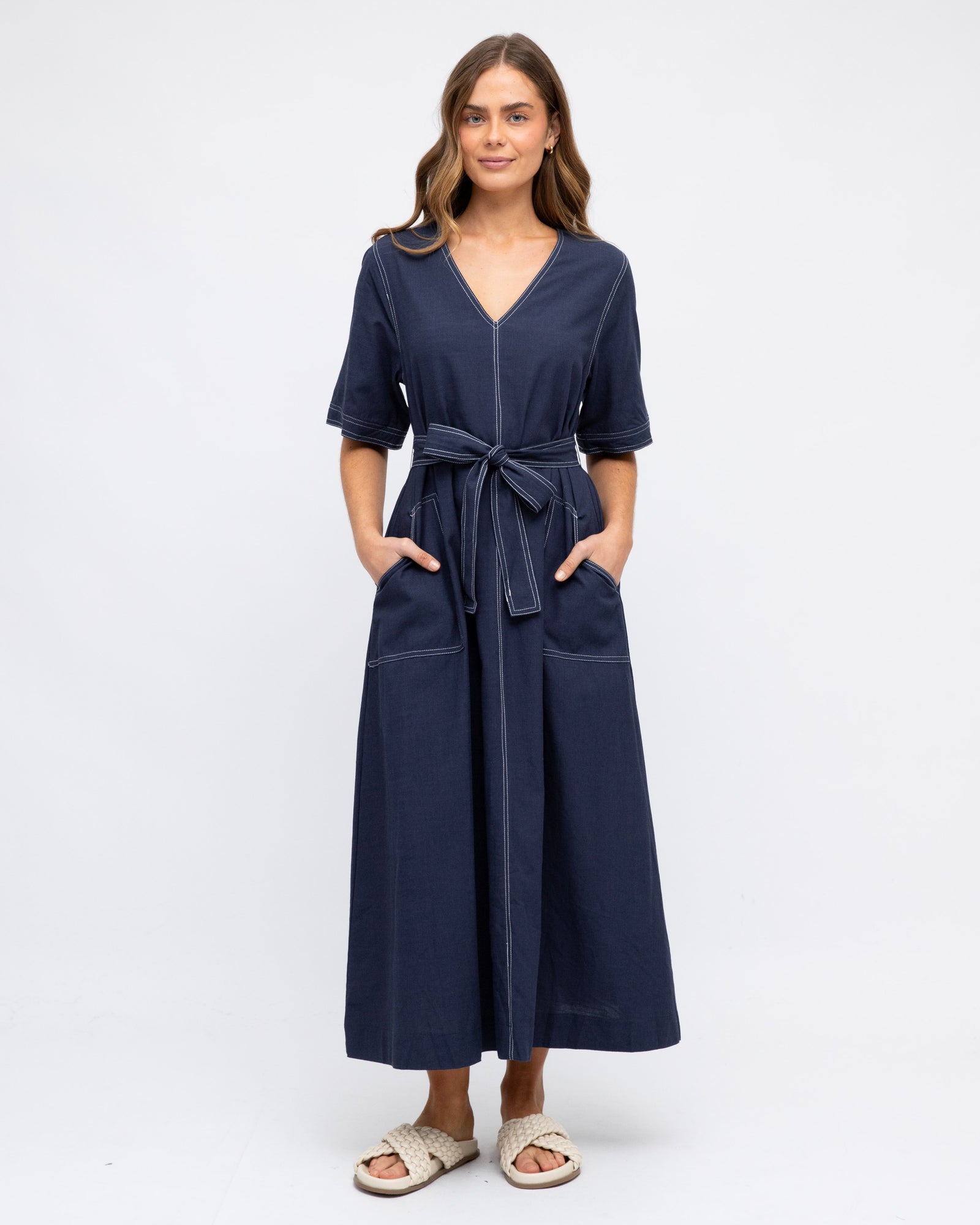 Lady wearing navy Blue contrast stitch maxi dress with front pockets, removable fabric tie waist and elbow length sleeves by label of Love.