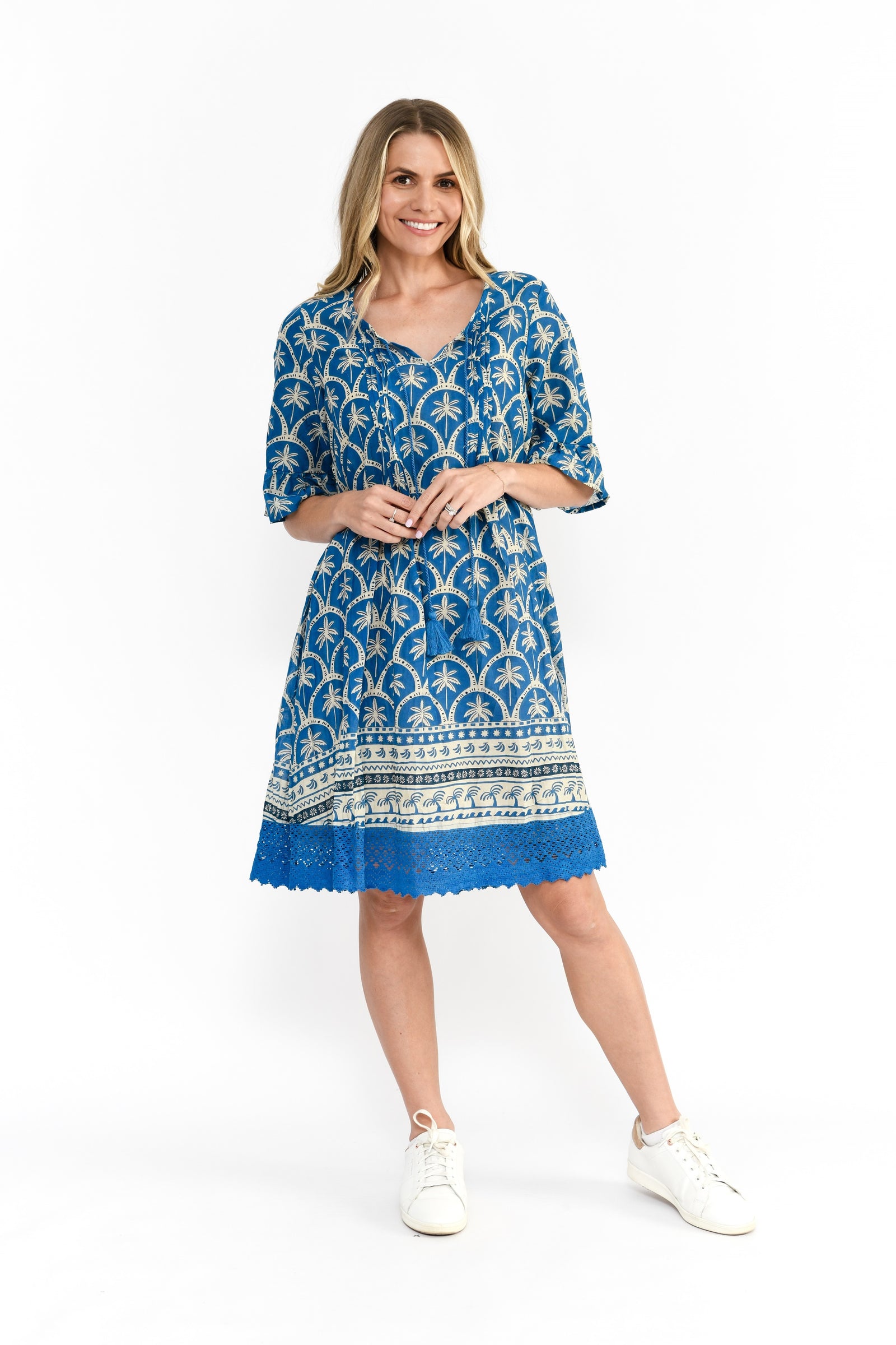 Woman wearing blue and beige Cotton Hannah Tunic Midi Dress with a v-neck and short sleeves with embroidered hem by One Summer.
