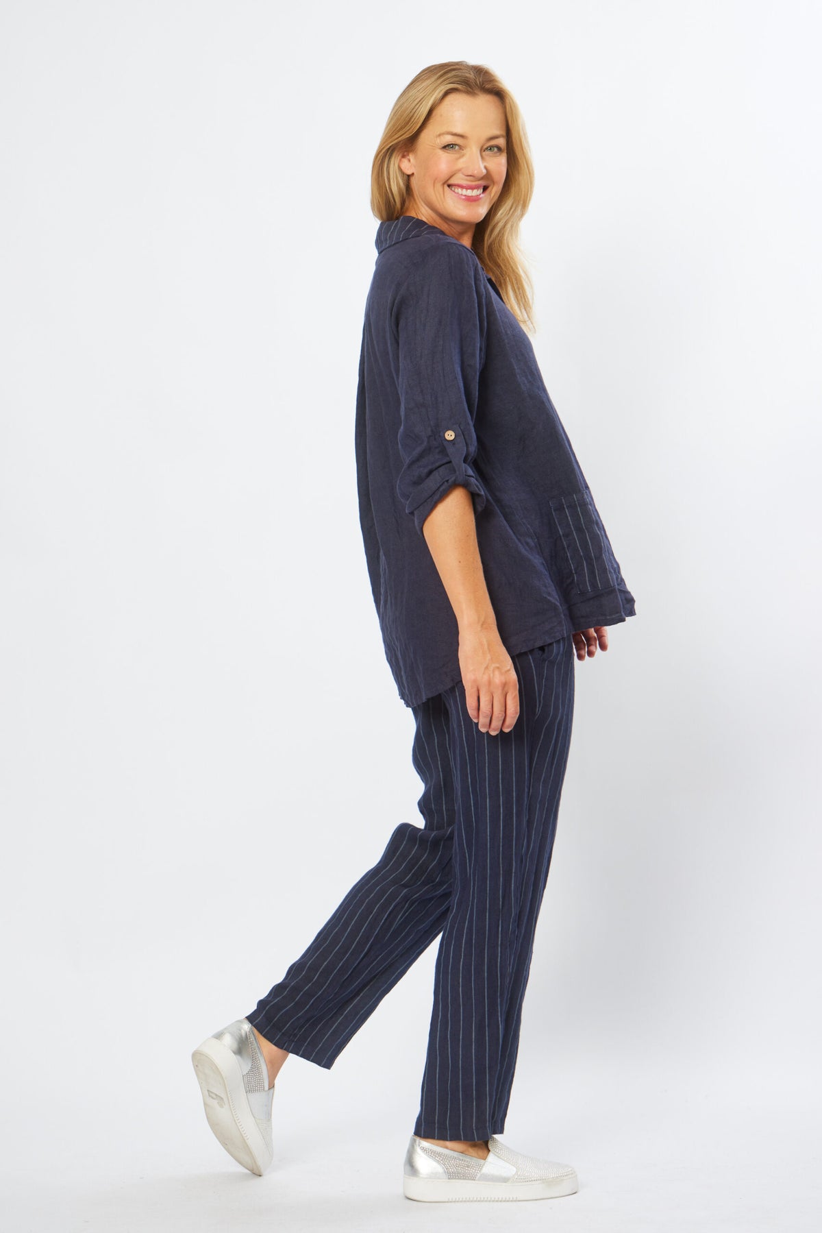 La Strada's blue linen blouse with striped pockets and collar, long sleeves with roll tab and high low hem.