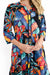 Woman wearing the Vivian multi coloured midi button up dress with a v-neck grandpa collar and knee length by One Summer.