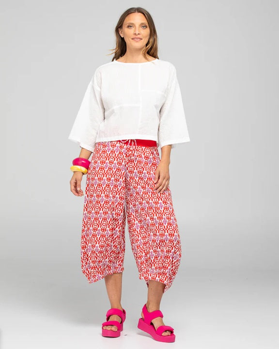 Lady wearing Boom Shankar's Cotton Cropped Guru Pants in Naples Pomodoro a fun red, white and pink print crop pant.