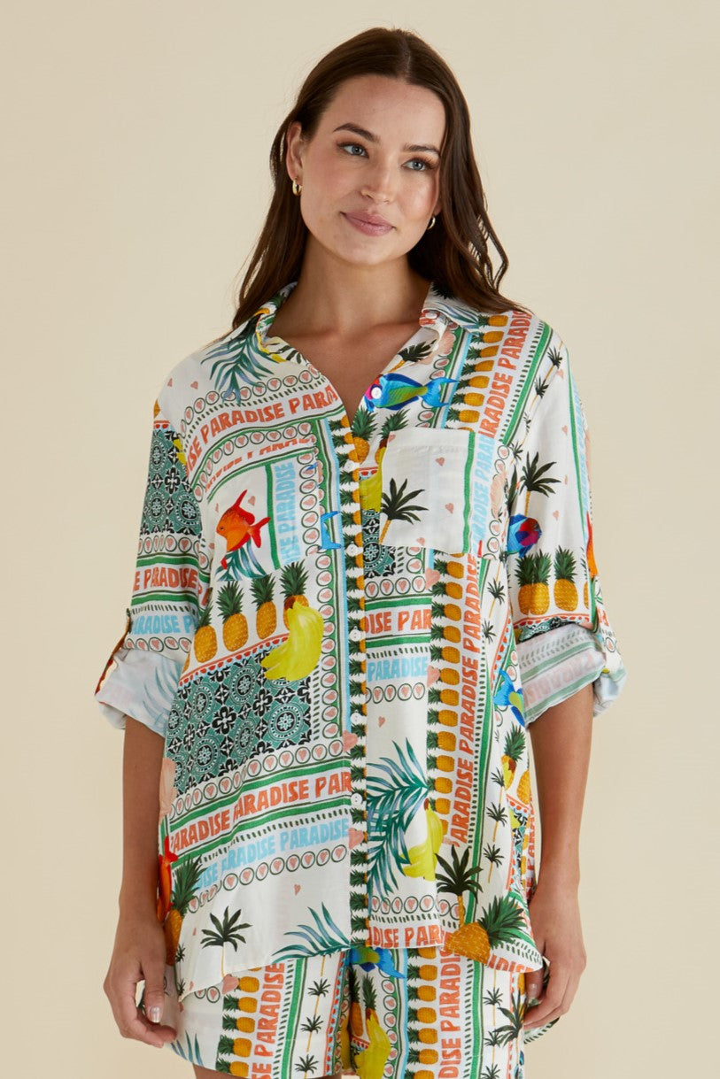 Woman wearing the Mills Shirt in paradise print by betty basics , has a classic collar, roll up tab for long or short sleeves and fun pineapple and fish tropical print.