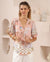 Woman wearing Island and Nautical print shirt with v-neck, mother of pearl buttons, short sleeves and curved hem by Iris Maxi.