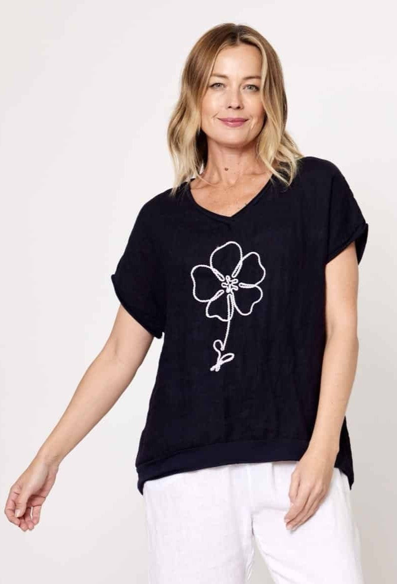 Model wearing La Strada's Navy Linen Tee with a white flower embroidered on the front. 