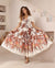 Woman weraing the iris maxi tropical botanical print dress with v-neck short sleeves and full skirt.