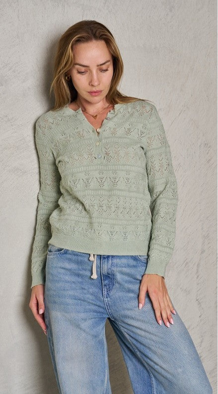 Woman wearing jade green enzio lightweight open weave knit top with pretty patterns and long sleeves from Label of Love.
