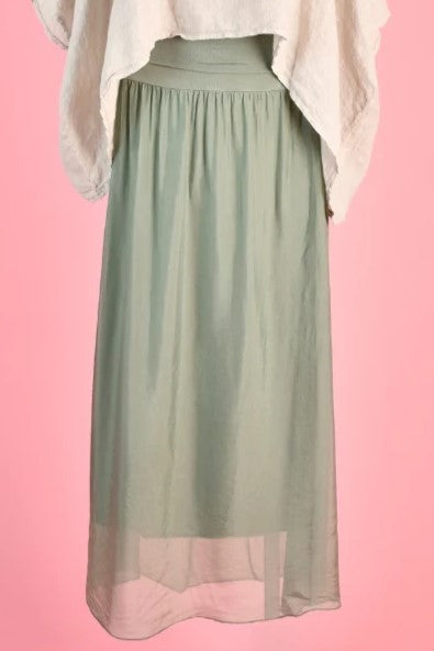 Woman wearing the lined Marta Silk blend maxi skirt in sage green by La Sofia.