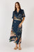 Woman wearing blue satin midi skirt with tigers and jungle print by Rubyyaya.