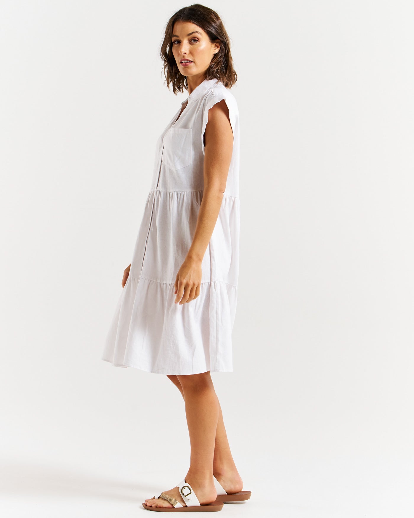 Side of tiered, v-neck midi dress with capped sleeves in white by betty basics.