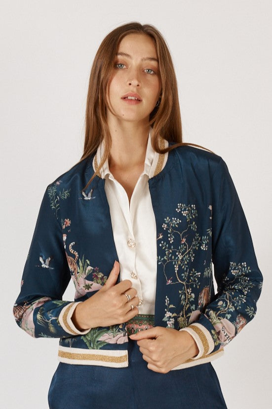 Woman wearing machali satin bomber jacket in navy blue with jungle and tiger print by Rubyyaya.