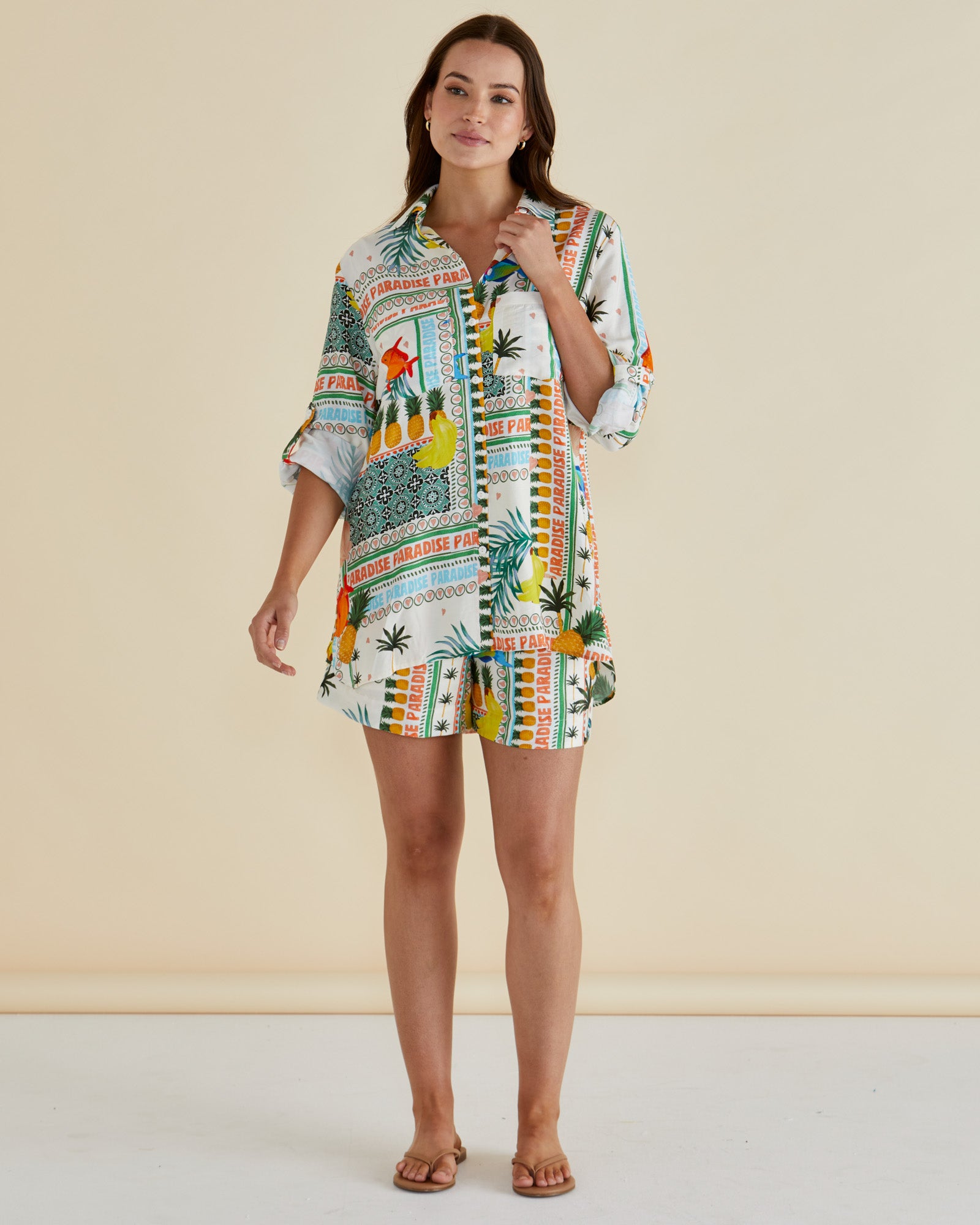 Woman wearing the Mills Shirt in paradise print by betty basics , has a classic collar, roll up tab for long or short sleeves and fun pineapple and fish tropical print.