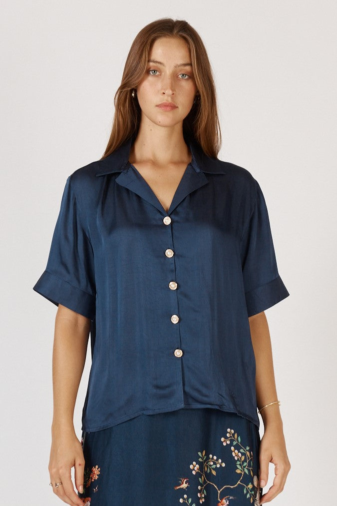 Woman wearing Satin Georgia Shirt with classic collar, button up front, short sleeves and straight hem by Rubyyaya.