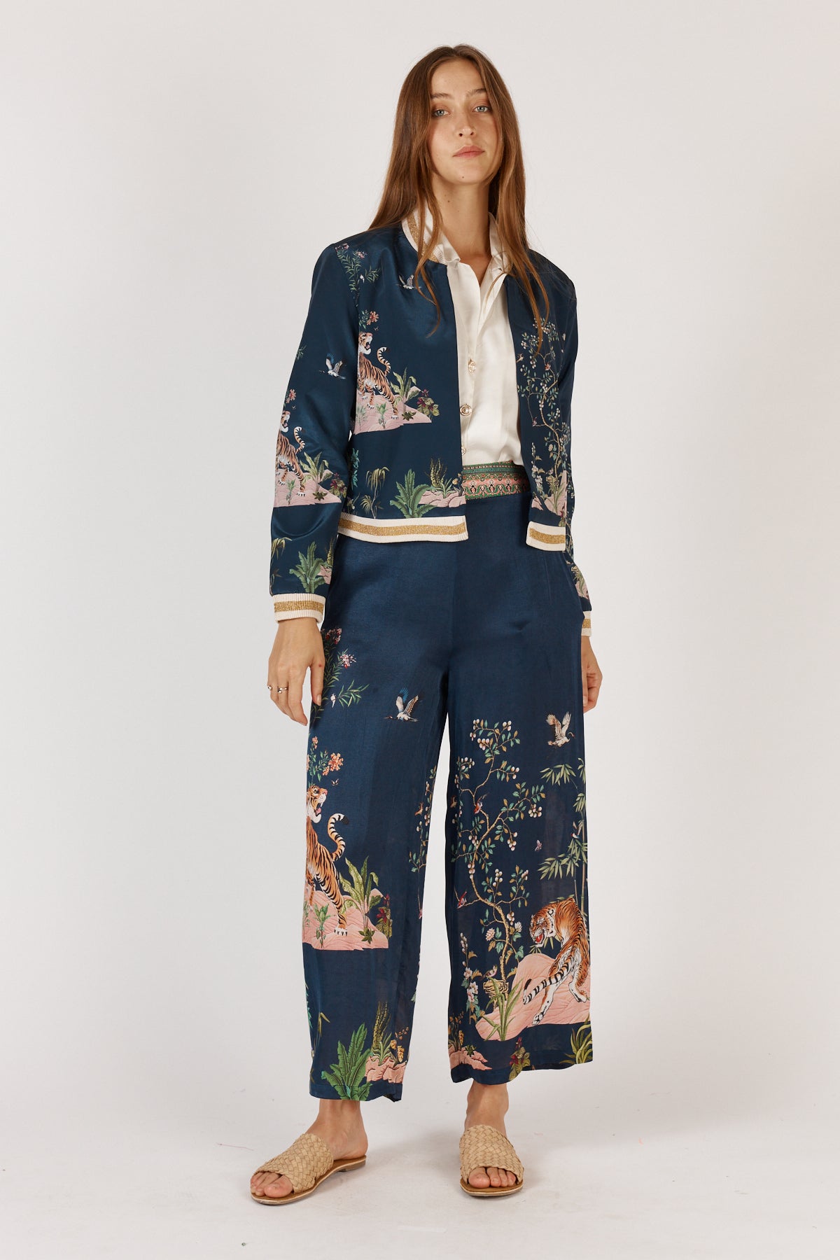 Woman wearing machali satin bomber jacket in navy blue with jungle and tiger print by Rubyyaya.
