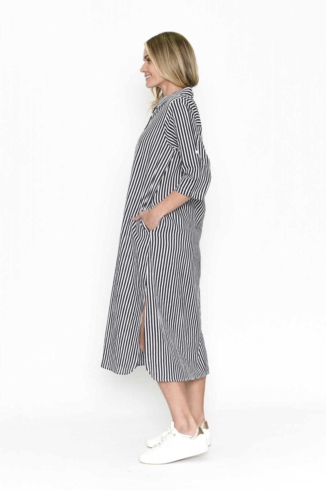Woman wearing navy blue and white striped midi shirt dress with collar and button up front, pockets and side splits this casual dress is from One Summer.