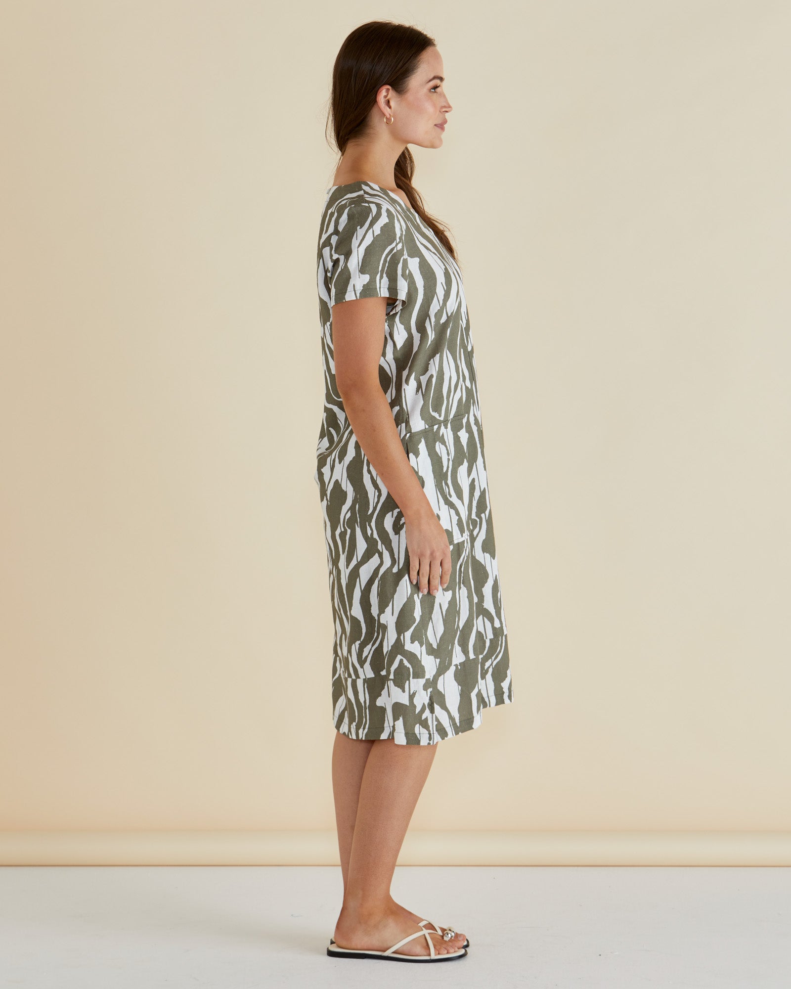Woman wearing Betty Basics Elwood tshirt midi dress in olive green and white geometric print with vneck and short sleeves.