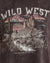 Woman wearing vintage black tshirt with wild west desert picture on the front, and pink stars on the short sleeves by Paper Heart.