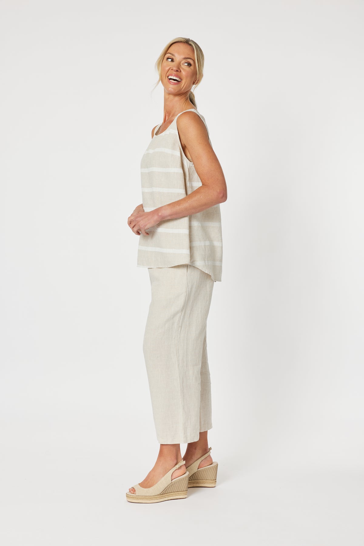 Patio Sleeveless Stripe Cami Tank Top in beige and White in a relaxed fit with high low hem curved at the back. 