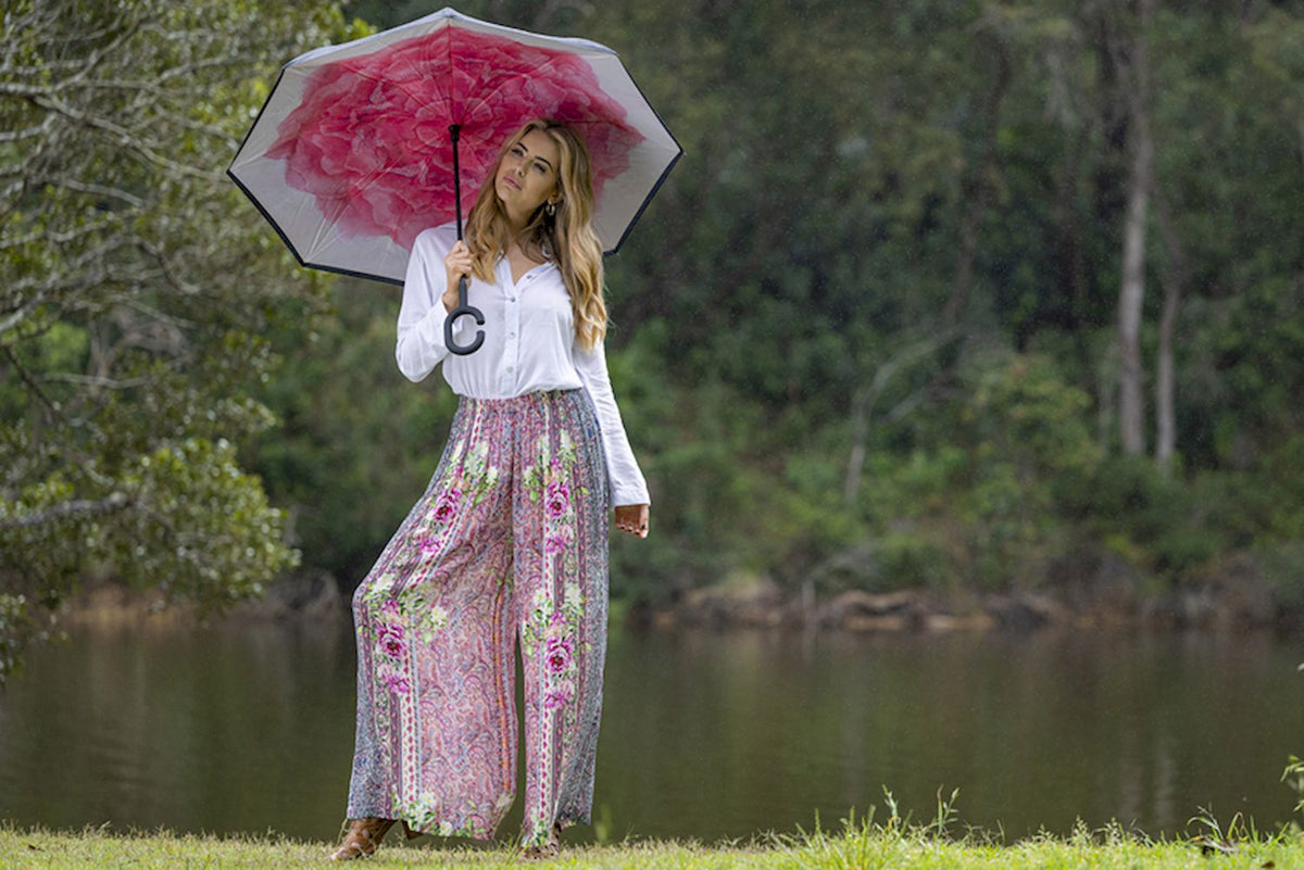 Model wearing Cienna's Camilla Wide Leg, harem style pant with a pink rose print.